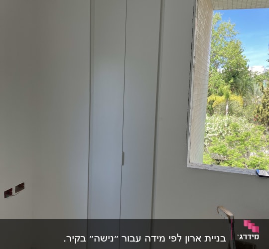 ארון קיר לבן עם דלתות סגורות בחדר